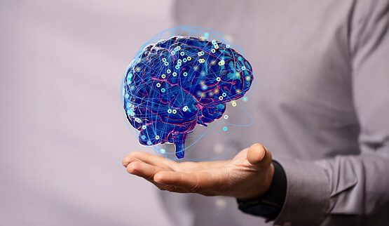 A pair of hands holding a glowing, interconnected digital brain or neural network, symbolizing advanced neurotech, AI-driven solutions, and digital innovation for corporate social responsibility (CSR).