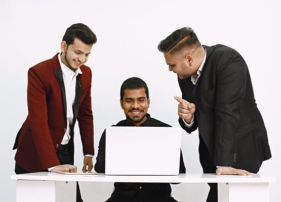 Two professionals intently reviewing data and discussing a project on a laptop, symbolizing business and IT consulting for the multi-vendor e-commerce platform.