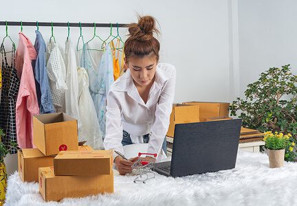 Wisitech portfolio: Image representing Amazon seller services, showing a person packing and processing orders on a laptop for Ecommerce marketing.