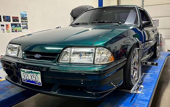 QuickTrick Alignment case study image showing a green car on a lift, highlighting SEO Enhancements, Content Strategy, and Performance Optimization as key platform features.