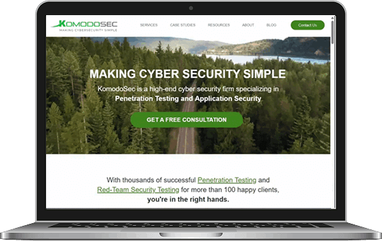 A laptop displaying the improved KomodoSec website homepage on the screen, highlighting the functional and visual success of the digital marketing project.