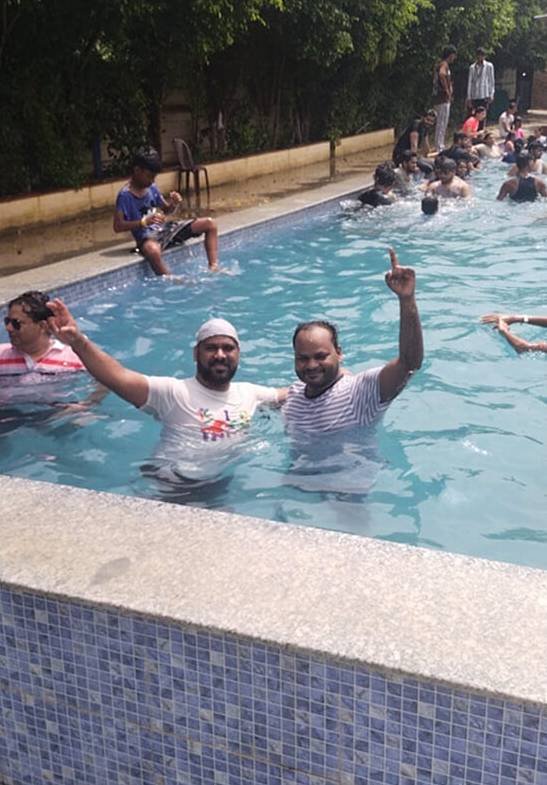 Wisitech team members enjoying a relaxing time in a swimming pool during a team outing, symbolizing fun and recharge beyond deadlines.
