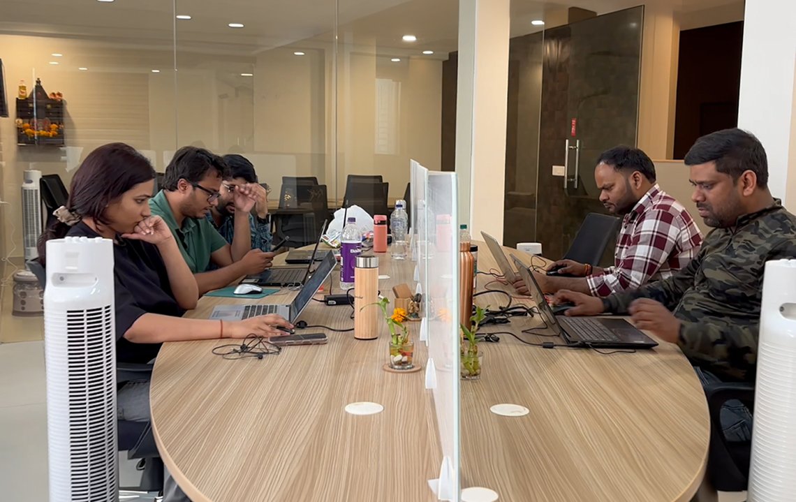 Wisitech web development team working on custom web development projects in the office